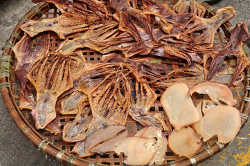 Local life lifestyle of Macanese people dried sun fish seafood for food preserves on bamboo wicker basket at outdoor on footpath beside road at Macao Special Administrative Region in Macau, China