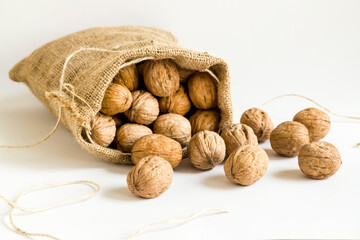 A sack of walnuts on white background with copy space