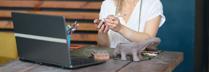 artisan pottery tutor in art studio. woman ceramist teaches an online lesson or leads a video...