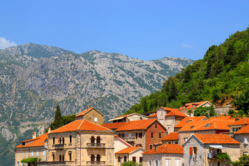 Obraz premium Old Historic buildings in Perast, Montenegro. A beautiful town in Kotor Bay in summer near high mountains. Adriatic Sea, Montenegro