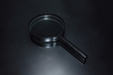 Large magnifier on a black - mirrored background