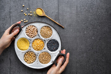 Variety of protein rich grains and legumes for a vegan diet. Millet, lentils, chickpeas, peas, soy, and oats. Top View.