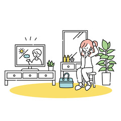 テレビを見ながら身だしなみを整える女性