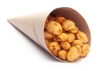 close-up of Roasted Crunchy Peanuts In handmade ( handcraft ) brown paper cone bag, made with peanuts. Pile of Indian spicy snacks (Namkeen),