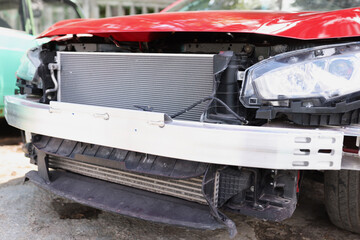 Closeup of red wrecked car in repair shop