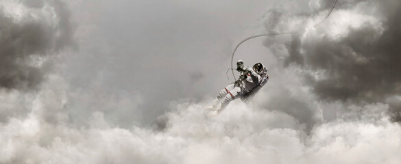 Astronaut flying on Unexplored world with the storm grey sky background. 3D illustration. Elements of this Image Furnished by NASA.