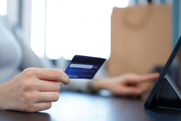Shopping online concept a young woman using her credit card to facilitate   an online purchasing in online shopping application