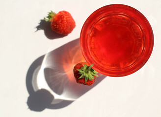 strawberry compote tincture with ice in glass glasses with strawberries and ice cubes
