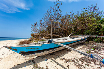 Naklejka na ściany i meble Blue and white fishing boat on the beach of Gili Air, Indonesia, Southeast Asia
