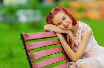 Smiling teen girl in dress in summer day - 444402410