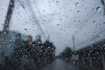 raindrops on window Abstract raindrops on car windshield, sky background, rainy season, images for nature background, selectable focus.