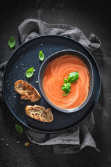Homemade tomato soup with basil and toasts.