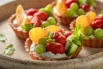 Sweet mini tart with strawberries and kiwi. Sweet fruit dessert.
