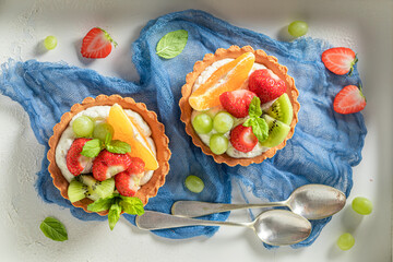 Sweet mini tart with various fruits. Simple summer dessert. © shaiith