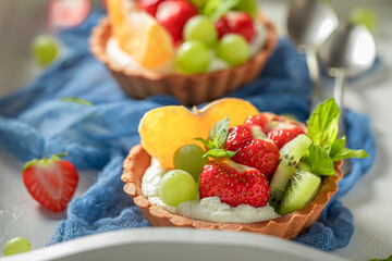 Sweet mini tart with various fruits. Sweet fruit dessert.