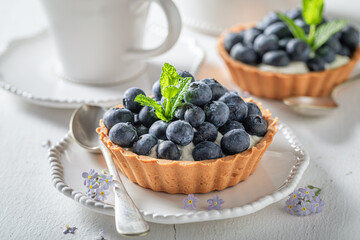 Tasty mini tart with blueberries and cream. - obrazy, fototapety, plakaty