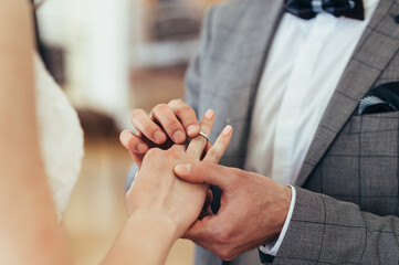 Obraz na płótnie Canvas wedding ceremony rings. a man puts a ring on a woman