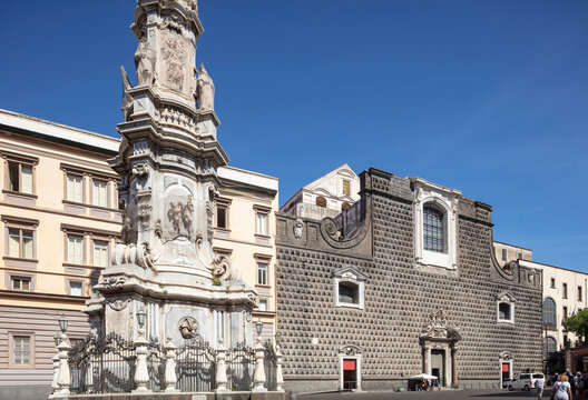 Naples, Italy, the peculiar Chiesa del Ges&ugrave; Nuovo with Obelisk of the Immaculate Conception, in the foreground