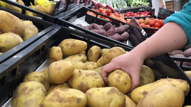 vegetables on the market customer selecting potato