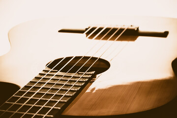 For music lovers. A close-up of the different parts of a wooden acoustic guitar such as the bridge, the body, the strings. 