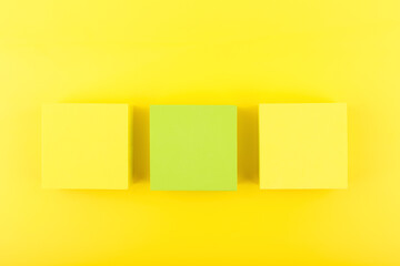 Abstract yellow background with yellow and light green cubes in a row.  Concept of template for design