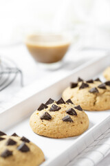 Delicious Whole Wheat Chocolate Chip Cookies set on white cafe table.