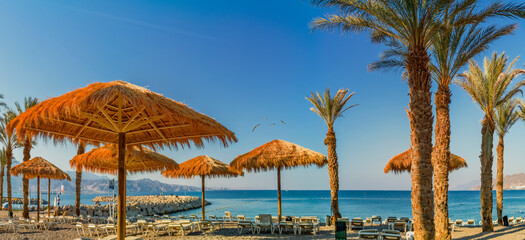 Morning on sandy beach of the Red Sea in Eilat - famous tourist resort city in Israel