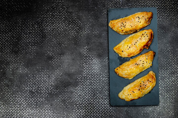 homemade puff pastry with chicken and mushroom on blackboard 