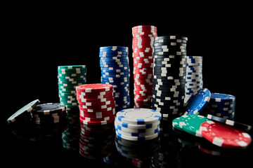 Stack of Casino gambling chips isolated on black reflective background