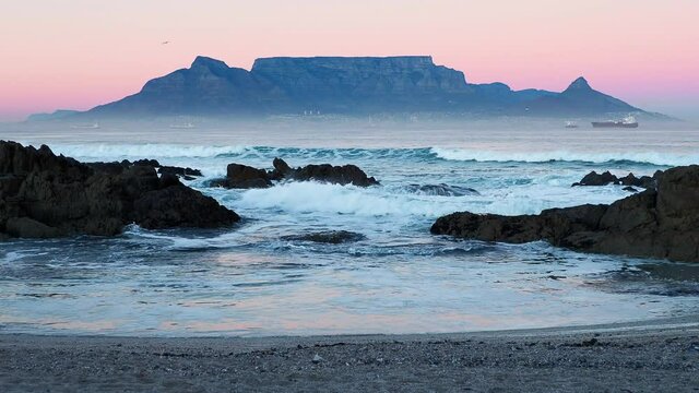 4K Twilight clip of Table Mountain across Table Bay from Bloubergstrand in Cape Town, South Africa.