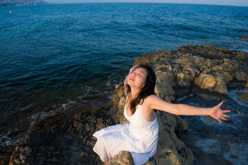 young happy and beautiful Asian woman by the sea - Attractive Korean girl cheerful enjoying relaxed summer holidays at tropical island in travel and lifestyle concept