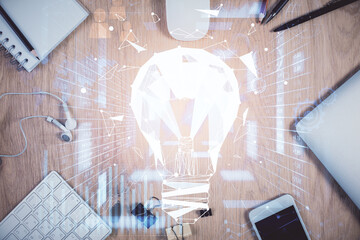 Double exposure of bulb drawing over table with phone. Top view. Concept of idea.