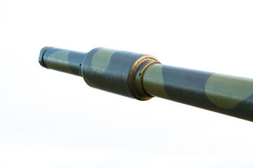 Barrel of a high caliber cannon in a defensive position on a hillside. Close up image.
