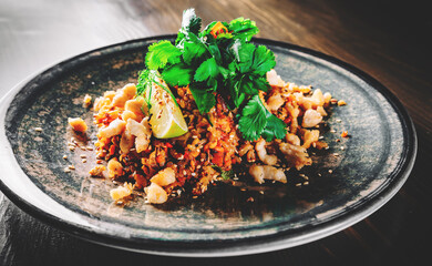 Fried rice with chicken and vegetables in plate on wooden table background
