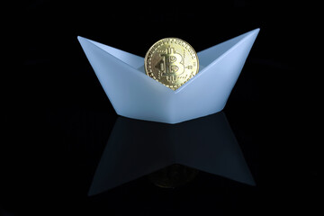 A bitcoin coin in a white boat on a black background.
