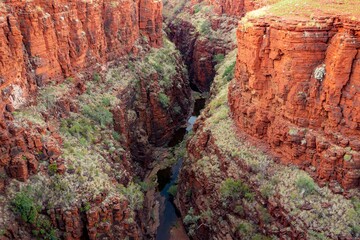 Landscape of Joffre Gorge with red cliffs and Joffre Creek in Western Australia