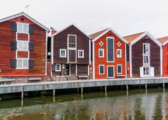 red and brown wooden warehouses along the waterfront in Hudiksvall
