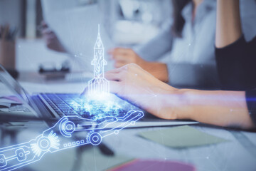 Double exposure of woman hands typing on computer and creative drawing. Start up concept.