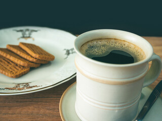 Cup of coffee and cookies on the table