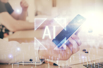 Double exposure of man's hand holding and using a digital device and data theme hologram drawing. Technology concept.