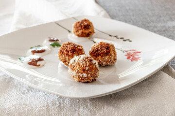 Tempeh meatballs in a white dish. Vegan sauces. Healthy recipe