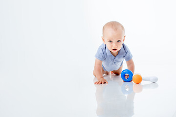 a baby boy with a multi-colored toys is isolated on a white background;