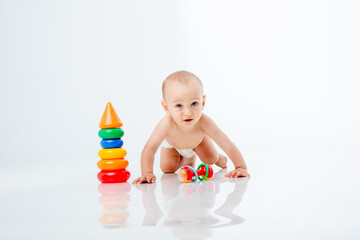 a baby boy with a multi-colored pyramid is isolated on a white background;