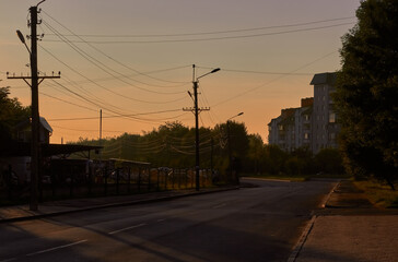 Sunrise. Landscape of the city, road and high-rise building. City street view. 