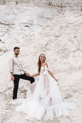 Beautiful wedding couple bride and groom at wedding day outdoors at ocean beach. Happy marriage couple o