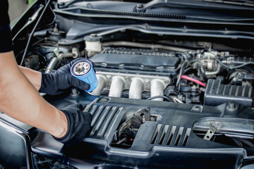 Fototapeta na wymiar Mechanic man change Engine oil filter for car maintenance concept in engine room