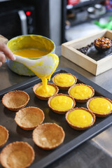 Asian girl cooking egg tart bakery . Houseworking food lifstyle and family concept.