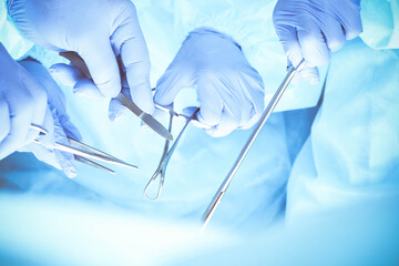 A group of surgeons is operating at the hospital, close-up of hands. Health care concept