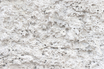 Obraz na płótnie Canvas The surface of rough, uneven hewn stone. Rough unpolished stone slab.