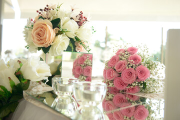 decoration of wedding table. flowers on a table in a  vase with mirror reflecting flowers